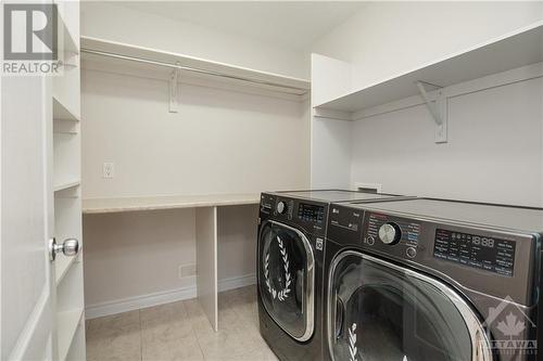 2nd Floor laundry with room for hanging plus a wall of storage behind the door - 107 Mangrove Crescent, Ottawa, ON - Indoor Photo Showing Laundry Room