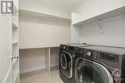 2nd Floor laundry with room for hanging plus a wall of storage behind the door - 