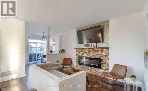 67 - 651 Farmstead Drive, Milton (Willmott), ON - Indoor Photo Showing Living Room With Fireplace