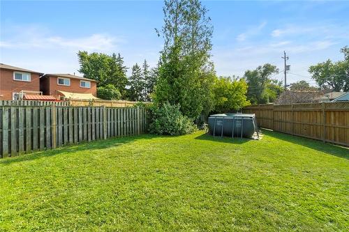 Fenced side yard with above ground pool - 734 Dunn Avenue, Hamilton, ON - Outdoor With Backyard