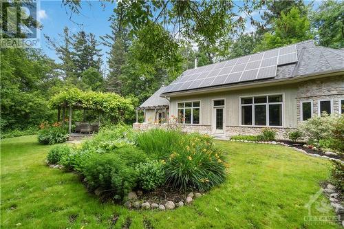 Side garden featuring the solar panels. - 698 Moffat Street, Pembroke, ON - Outdoor