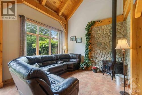 Living room with a wood stove. - 698 Moffat Street, Pembroke, ON - Indoor Photo Showing Living Room With Fireplace