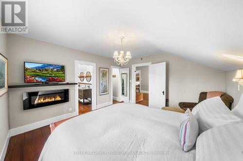 7243 Concession 1, Puslinch, ON - Indoor Photo Showing Bedroom With Fireplace