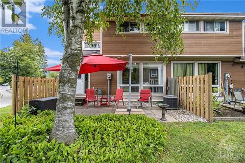 The private backyard is perfect for outdoor entertaining, gardening, or simply relaxing in your own serene space. Surrounded by lush greenery and offering a sense of seclusion, this backyard provi - 4629 Carrington Place, Ottawa, ON - Outdoor With Deck Patio Veranda