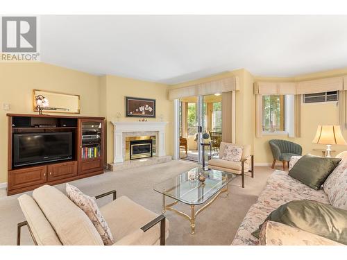 945 Lawrence Avenue Unit# 104, Kelowna, BC - Indoor Photo Showing Living Room With Fireplace