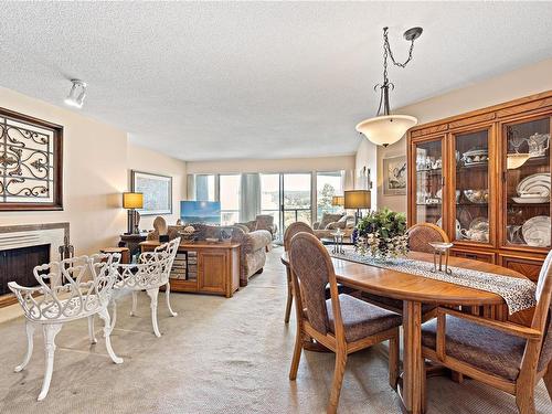 501-2560 Departure Bay Rd, Nanaimo, BC - Indoor Photo Showing Dining Room With Fireplace