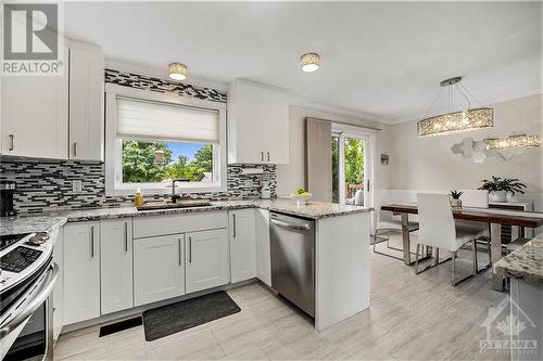 Open concept kitchen and dining area with access to back deck via patio door - 1657 7Th Line Road, Carleton Place, ON - Indoor Photo Showing Kitchen With Upgraded Kitchen