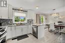 Open concept kitchen and dining area with access to back deck via patio door - 1657 7Th Line Road, Carleton Place, ON  - Indoor Photo Showing Kitchen With Upgraded Kitchen 