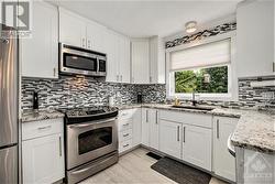 updated kitchen with stainless steel appliances and granite counter tops - 