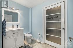 new powder room in lower level with handy pocket door to block off laundry room - 