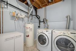 laundry room lower level with new owned hot water tank - 