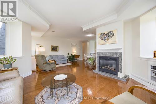 401 - 200 Collier Street, Barrie, ON - Indoor Photo Showing Living Room With Fireplace