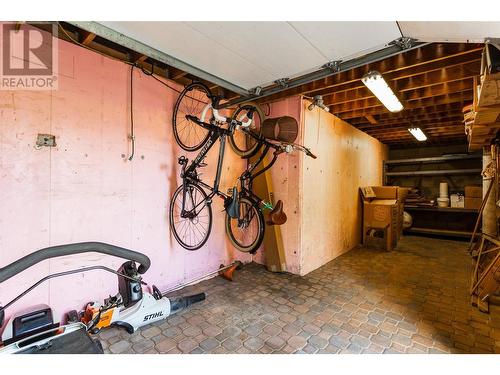 storage by rear yard with overhead garage door. - 1831 Horizon Drive, West Kelowna, BC - Indoor Photo Showing Basement