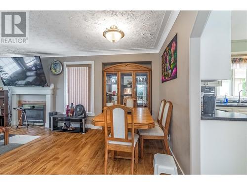 1353 Friesen Road, Kelowna, BC - Indoor Photo Showing Dining Room With Fireplace