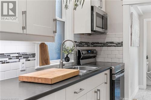 Exuding contemporary elegance with its clean lines, modern finishes, and sophisticated design, the kitchen is a stylish and functional space for all your culinary adventures. - 1371 3Rd Avenue E, Owen Sound, ON - Indoor Photo Showing Kitchen With Double Sink