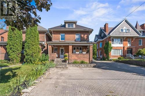 This classic century home, complemented by an elegant interlocking brick driveway, exudes charm and character, offering a beautiful blend of historic sophistication and modern curb appeal. - 1371 3Rd Avenue E, Owen Sound, ON - Outdoor With Facade