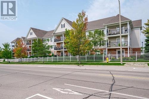 209 - 106 Aspen Springs Drive, Clarington (Bowmanville), ON - Outdoor With Balcony With Facade