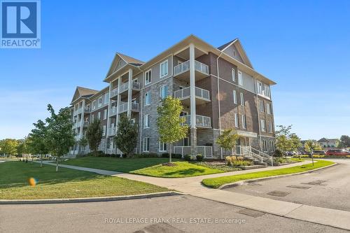 218 - 290 Liberty Street N, Clarington (Bowmanville), ON - Outdoor With Balcony With Facade