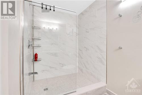 THis unit features a unique custom walk-in shower with glass enclosure and ceramic base and surround. - 330 Royal Fern Way, Ottawa, ON - Indoor Photo Showing Bathroom