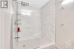 THis unit features a unique custom walk-in shower with glass enclosure and ceramic base and surround. - 