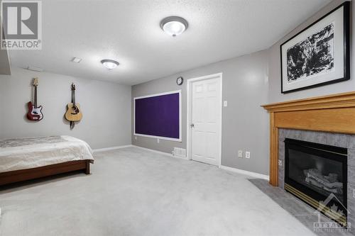 Comfy Family Room with Gas Fireplace! - 14 Carwood Circle, Ottawa, ON - Indoor Photo Showing Bedroom With Fireplace