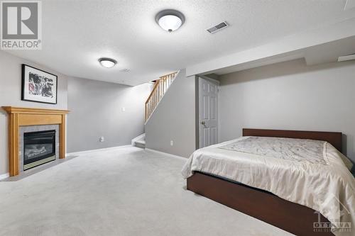 Put in a Pull Out Couch for your guests to stay - 14 Carwood Circle, Ottawa, ON - Indoor Photo Showing Bedroom With Fireplace