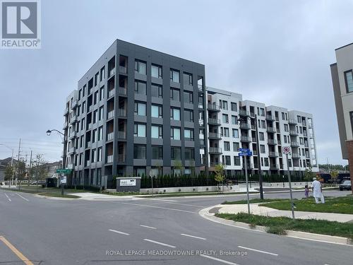 401 - 1440 Clarriage Court W, Milton (Ford), ON - Outdoor With Balcony With Facade