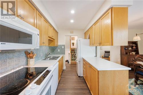 Open to Family Room + Dining Room - 31 Reaney Court, Kanata, ON - Indoor Photo Showing Kitchen With Double Sink