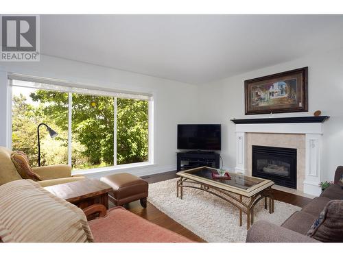 310 Woodcrest Court, Kelowna, BC - Indoor Photo Showing Living Room With Fireplace