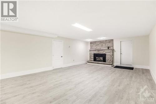 Lower Level Family Room w/ gas fireplace - 273 Roger Road, Ottawa, ON - Indoor Photo Showing Living Room With Fireplace