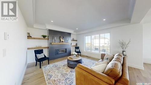 107 Woolf Bend, Saskatoon, SK - Indoor Photo Showing Living Room With Fireplace