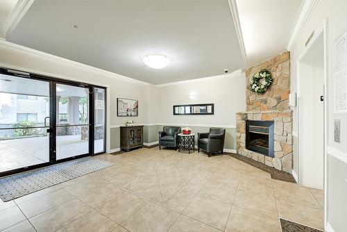 306-1007 Harvey Avenue, Kelowna, BC - Indoor Photo Showing Other Room With Fireplace