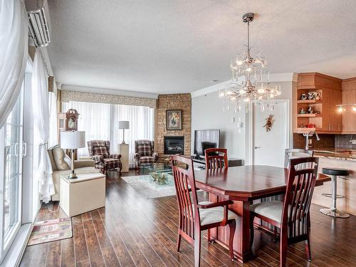 Vue d'ensemble - 303-1101 Boul. Lucille-Teasdale, Terrebonne (Lachenaie), QC - Indoor Photo Showing Dining Room With Fireplace