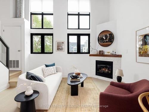 204-525 Logan Ave, Toronto, ON - Indoor Photo Showing Living Room With Fireplace