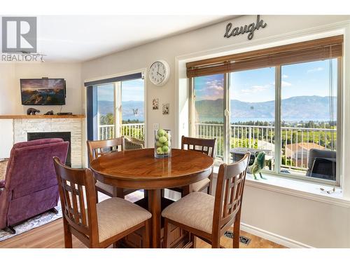 2613 Copper Ridge Drive, West Kelowna, BC - Indoor Photo Showing Dining Room With Fireplace