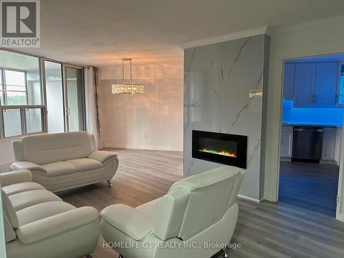 516 - 60 Pavane Linkway, Toronto (Flemingdon Park), ON - Indoor Photo Showing Living Room With Fireplace