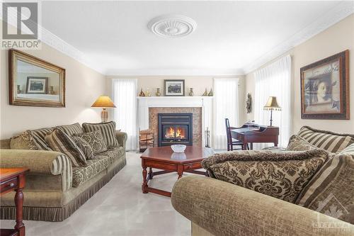 Relax and enjoy the warmth of the air-tight, wood burning fireplace in the spacious Living room. - 74 Trailway Circle, Ottawa, ON - Indoor Photo Showing Living Room With Fireplace