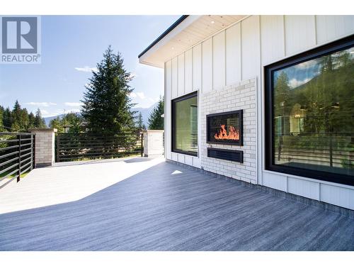 Front Deck with Indoor/Outdoor Fireplace off Family Room - 2043 Airport Way, Revelstoke, BC -  With Fireplace