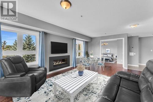 1204 - 330 Prince Charles Drive S, Welland, ON - Indoor Photo Showing Living Room With Fireplace