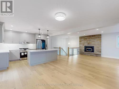 180 The Queensway Road N, Georgina (Historic Lakeshore Communities), ON - Indoor Photo Showing Kitchen With Fireplace With Upgraded Kitchen