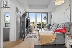 living area and door to bedroom on left, balcony at the front - 