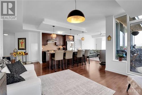 Designer pendant light can be lowered if converted back to dining room area - 575 Byron Avenue Unit#413, Ottawa, ON - Indoor Photo Showing Living Room