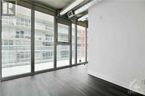 BEDROOM | full wall of windows, with custom blinds, overlooks balcony and onto the courtyard - 354 Gladstone Avenue Unit#502, Ottawa, ON - Indoor Photo Showing Other Room