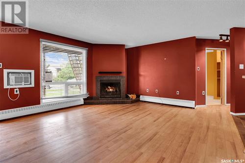 105 2911 Harding Street, Regina, SK - Indoor Photo Showing Living Room With Fireplace