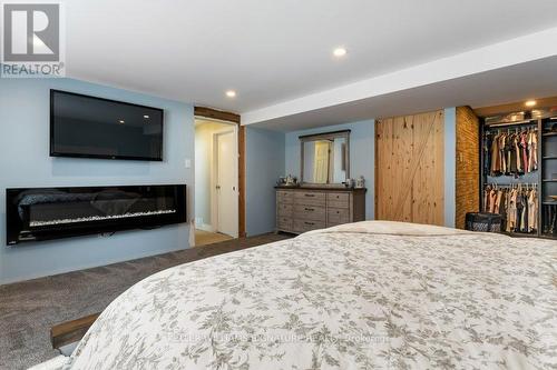 4999 Canborough Road, West Lincoln, ON - Indoor Photo Showing Bedroom With Fireplace