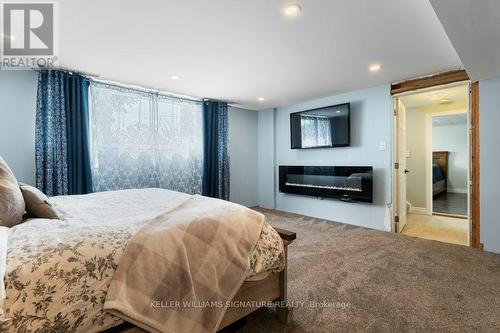 4999 Canborough Road, West Lincoln, ON - Indoor Photo Showing Bedroom With Fireplace