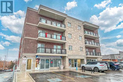 203 - 310 Broadway Avenue, Orangeville, ON - Outdoor With Balcony With Facade