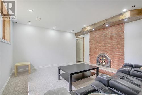 Lower level family/entertainment/home theatre room with double sided fireplace - 129 Spinnaker Way, Woodlawn, ON - Indoor