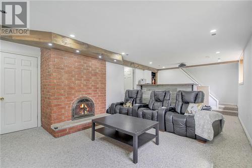 Lower level family/entertainment/home theatre room with double sided fireplace - 129 Spinnaker Way, Woodlawn, ON - Indoor With Fireplace