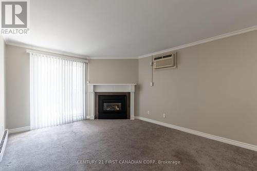 213 - 440 Wellington Street, St. Thomas, ON - Indoor Photo Showing Living Room With Fireplace